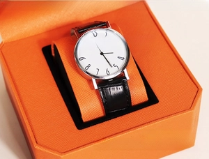 Close-up of premium orange PU leather watch box with a classic white dial timepiece