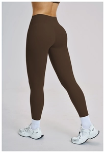 Rear view of dark brown high-waisted yoga pants with butt-lifting cut and matte finish