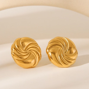 Detailed close-up of golden stainless steel stud earrings with spiral vortex design