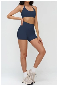 Detailed view of women's dark blue sports bra and high-waist shorts workout set