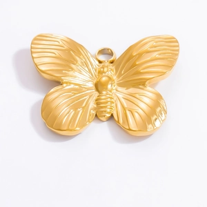 Macro detail of a 18k gold-plated bow charm with intricate wing textures for DIY jewelry
