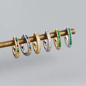 Close-up of six s925 silver hoop earrings with rainbow, white, and green zircons