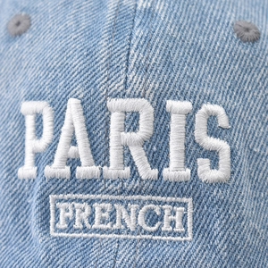 Faded blue denim baseball cap featuring white embroidered PARIS text on the front crown