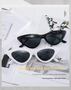 Detailed view of stylish cat eye sunglasses in black and white glossy resin frames