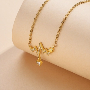 Close-up of golden heartbeat necklace with micro-paved zircon and heart-shaped charm