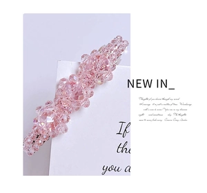 Close-up of sparkling pink crystal beads on a refined spring hair clip for women