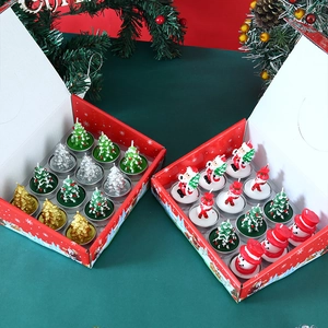 Close-up of 12-piece Christmas tree and snowman candle gift sets in festive red boxes
