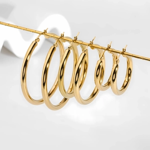 Set of four 18K gold plated stainless steel hoop earrings in various sizes on white props