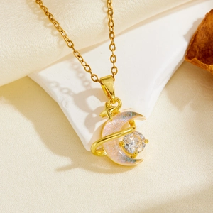 Detail of gold star and moon pendant necklace with purple pearlescent finish and zircon