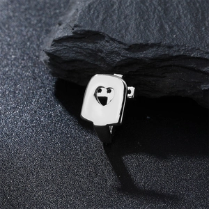 Macro shot of silver rectangular signet ring with heart cutout on a dark stone