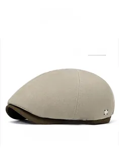 Detail of apricot grey newsboy cap showing metal square decor and retro canvas texture