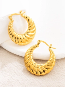 Detail of 18K gold plated stainless steel croissant hoop earrings on a stone display