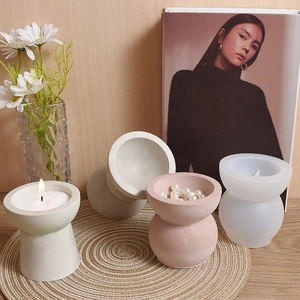 Detailed view of hourglass silicone mold and finished geometric DIY candle holders