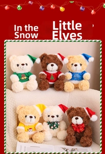 Detailed view of Christmas teddy bears in red and green festive sweaters on a plush sofa