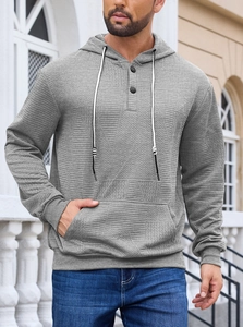 Close-up of men's gray hoodie featuring premium waffle texture and buttoned neckline