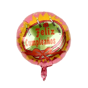 Detail of round foil balloon with cake design and Feliz Cumpleaños Spanish greeting
