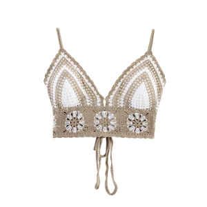 Knitted halter neck crop top with hollow out crochet floral patterns and fringe tassels