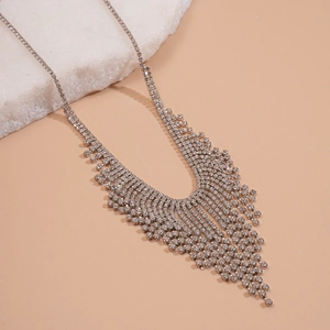 Macro shot of silver tassel necklace with rhinestones in a V-shape design for formal events