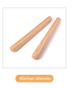 Close-up of two polished wooden rolling pins with smooth natural grain on white background