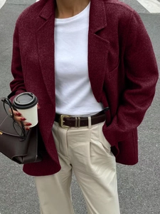 Burgundy casual blazer styled with white tee and beige trousers on an outdoor street