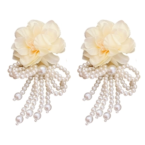 Floral bow pearl tassel earrings in beige fabric for a sweet bohemian holiday look