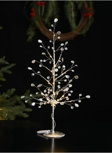 Close-up of LED crystal Christmas tree ornament with silver wire and beads