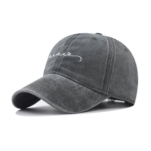 Close-up of vintage washed cotton baseball cap with white script letter embroidery