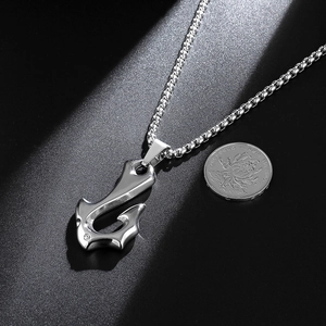Silver stainless steel fishhook pendant necklace with box chain on black background