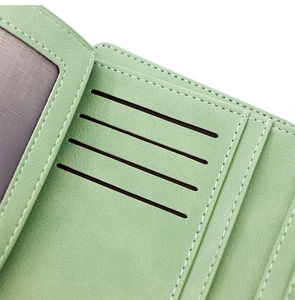 Detailed interior of green PU leather wallet showing four card slots and precise white stitching