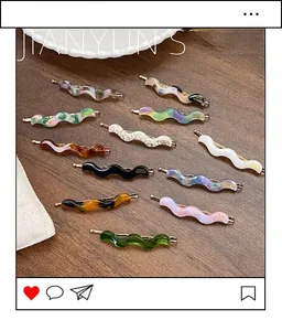 Detailed flat lay of wave-shaped acetate hair clips in multiple colors on wood surface