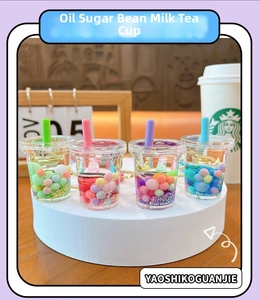 Detailed set of four creative liquid quicksand milk tea cup keychains with colorful pearls
