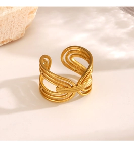 Detail of a gold layered interwoven open ring with artistic wavy metal lines