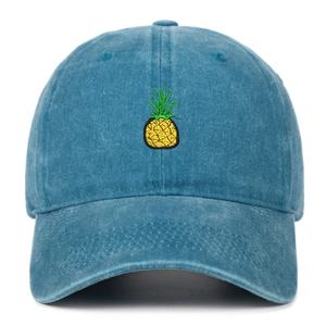 Close-up of yellow pineapple embroidery on vintage navy washed cotton baseball cap