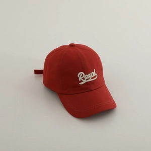 Detail of deep red cotton baseball cap featuring white Royal cursive embroidery texture