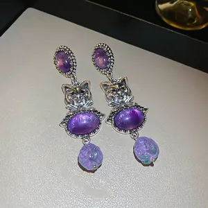 Vintage silver cat earrings with purple crystals and intricate feline carvings