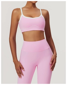 Détail de l'ensemble de yoga rose avec fines bretelles, bordure blanche et coutures courbes