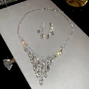 Elegant silver tassel necklace and oval crystal earring set for formal evening wear