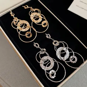 Hammered textured knot circle drop earrings in gold and silver finish shown in a gift box