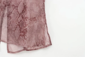 Detail shot of sheer pink snakeskin chiffon blouse featuring fine rolled hem stitching