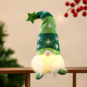 Detail of a Christmas gnome doll with a green knitted star hat and glowing LED white beard