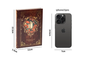 Size comparison of the vintage gold-stamped notebook next to an iPhone 15 Pro