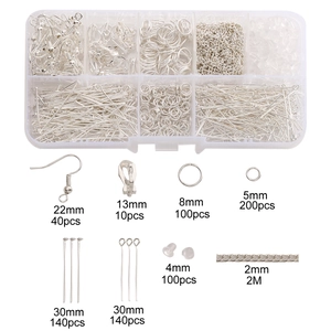 Macro view of DIY jewelry making kit with silver earring hooks, jump rings and chains