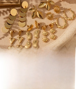 Macro shot of gold-plated titanium steel earrings in heart and crescent shapes