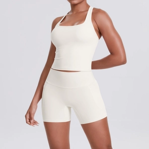 Detail of racerback sports tank and high-waisted shorts with side pockets in cream white