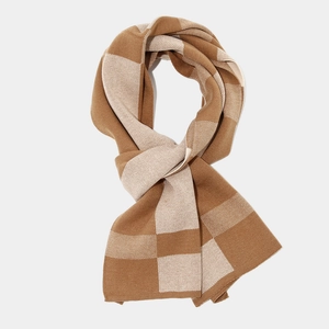 Detail of caramel and beige checkered knit scarf with thick wool texture and neat edges