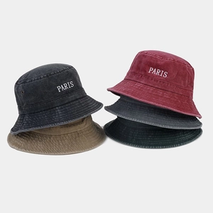 Detail of PARIS embroidered washed cotton bucket hats in dark grey, burgundy, and khaki colors