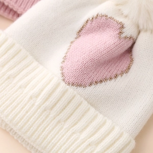 White knitted baby hat with pink heart jacquard and white pompom for 0-12 months