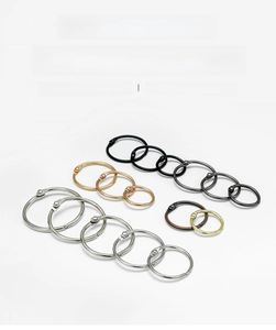 Close-up of metal binder rings in silver gold and bronze finishes for loose-leaf books