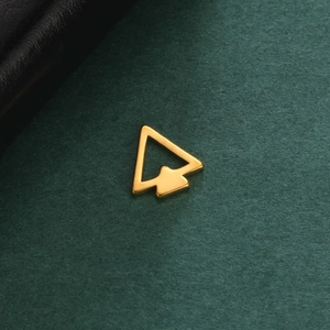 Close-up of a minimalist golden double arrow stainless steel pendant on a dark texture