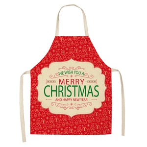 Detail of linen Christmas apron featuring festive reindeer and Santa Claus print patterns